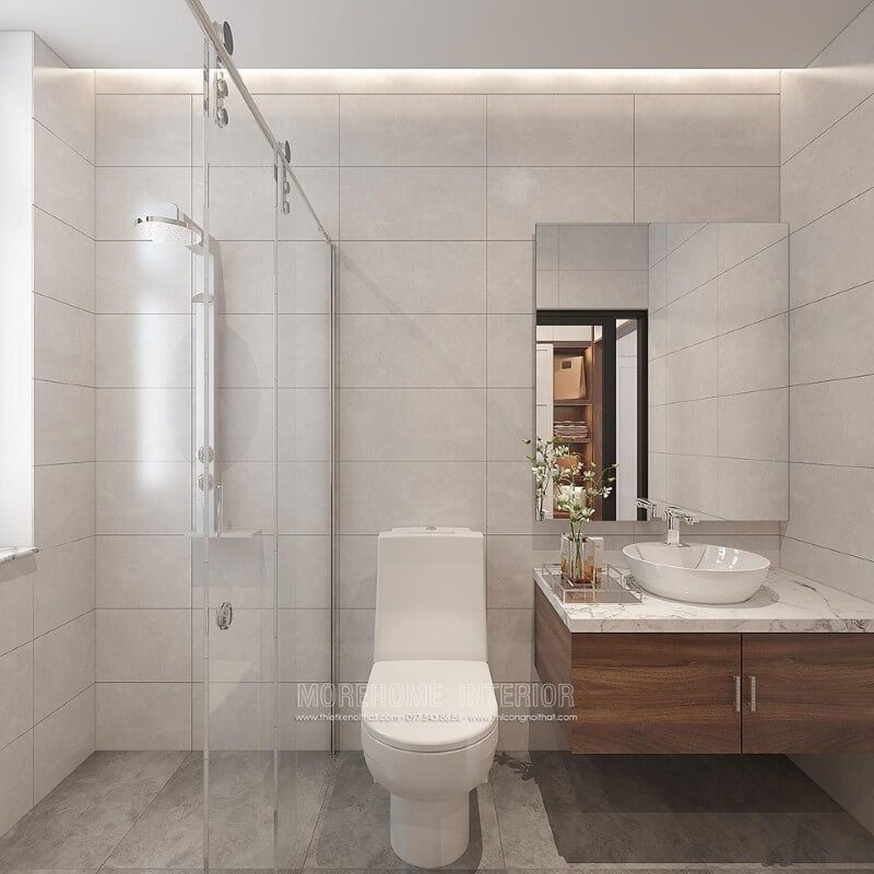 Thiết kế phòng tắm chung cư theo phong cách hiện đại đẹp với cách lựa chọn đồ vật tinh gọn nhưng lại tạo vẻ đẹp sang trọng cuốn hút từ tường ốp gạch giả bê tông, gương hiện đại không khung ốp tường, phòng tắm kính cửa trượt. Thiết kế nội thất chung cư phong cách hiện đại đẹp, trẻ trung